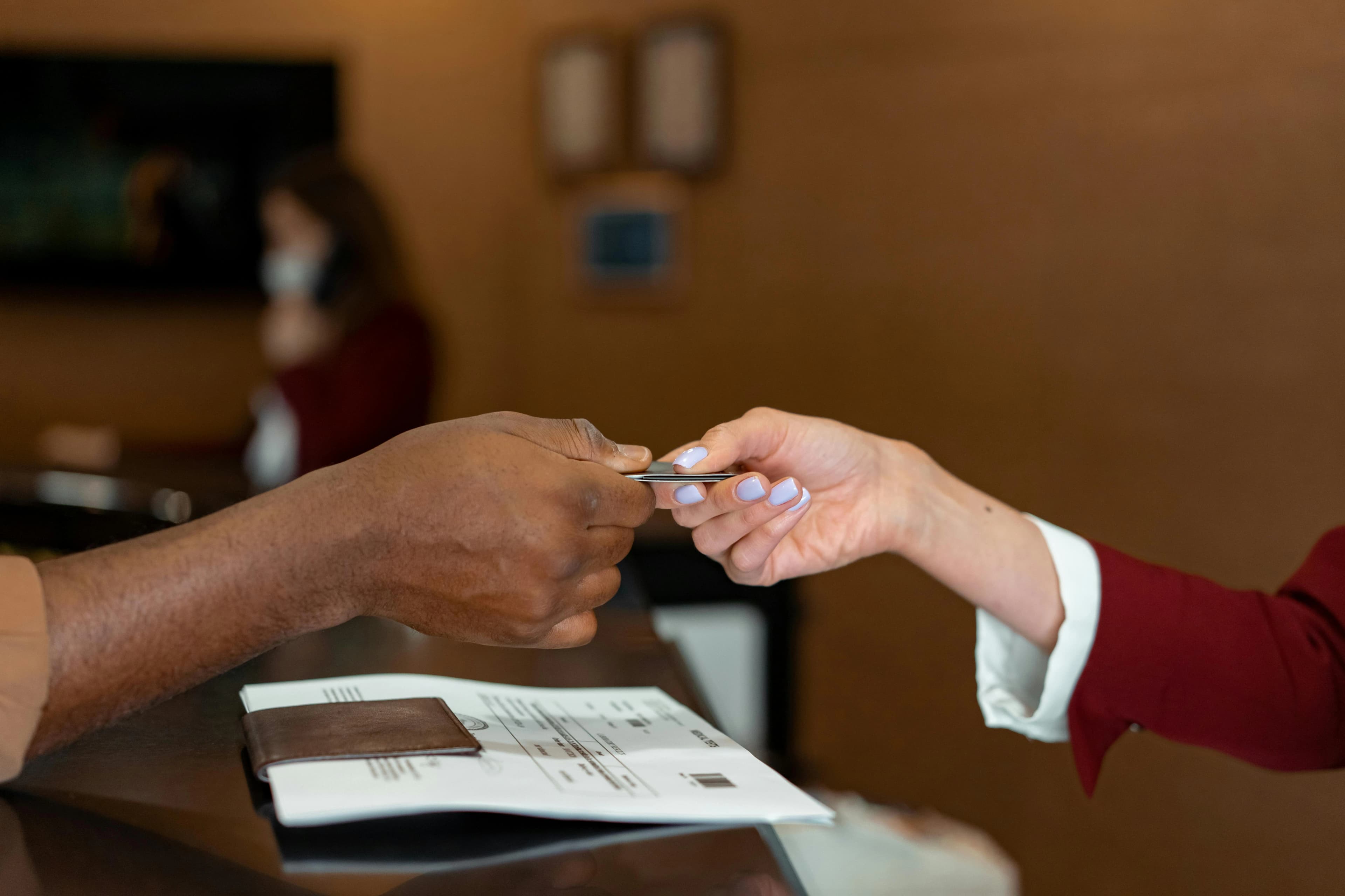 Guest and staff exchanging a payment card at a restaurant counter