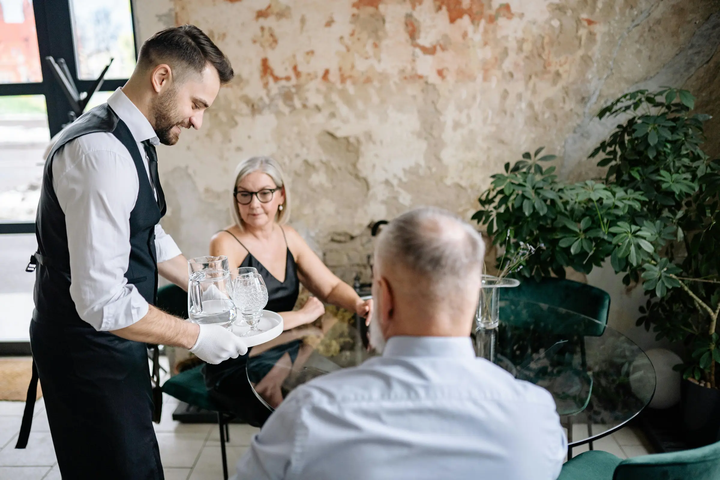 Restaurant team serving guests in a bright dining room