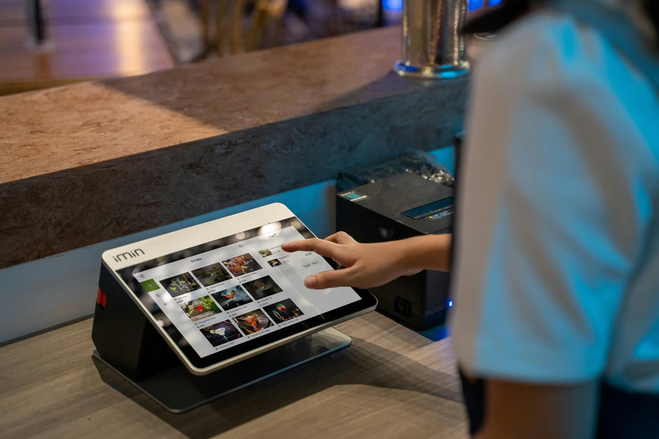 Restaurant staff using a reservation tablet to manage live table availability