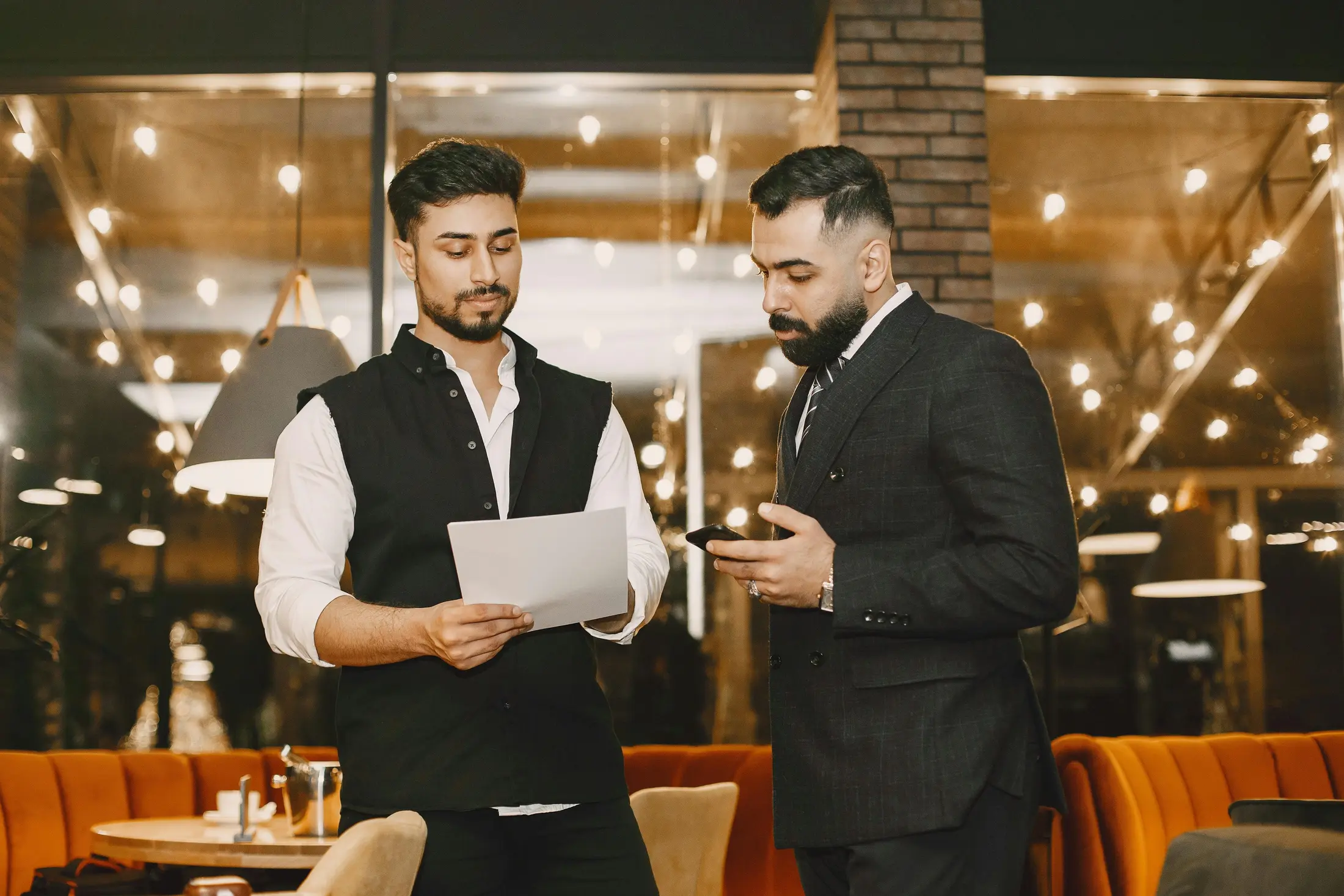 Front-of-house team coordinating in-restaurant service while managing incoming calls